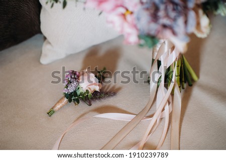 wedding bouquet with roses and boutonniere.The decor at the wedding.