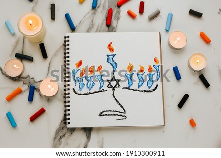 Celebration card with menorah (traditional candelabra) and candles for Happy Hanukkah jewish holiday drawing by child.