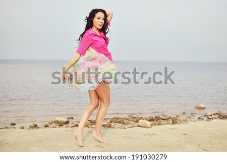 Feeling of freedom, young brunette woman by the sea.