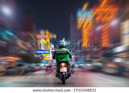 Food delivery drivers are driving to deliver products to customers who order online. Impact of epidemics Royalty-Free Stock Photo #1910308831