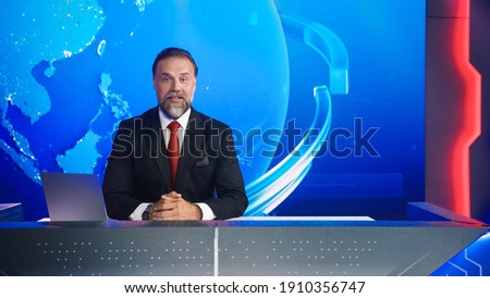 Live News Studio with Professional Male Newscaster Reporting on the Events of the Day. Broadcasting Channel with Presenter, Anchor Talking. Mock-up TV Newsroom Set with News Ticker. Royalty-Free Stock Photo #1910356747