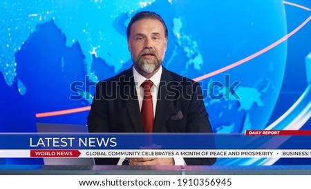 Live News Studio with Professional Anchor Reporting on the Events of the Day. Television Channel Newsroom with Newscaster Talking. Running Ticker Shows Latest News. Royalty-Free Stock Photo #1910356945
