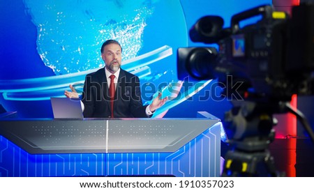 Live News Studio with Professional Male Newscaster Reporting on the Events of the Day. TV Broadcasting Channel with Presenter, Anchor Talking. Mock-up Television Channel Newsroom Set.
