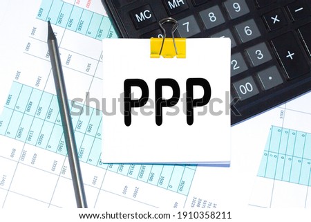 text, calculator and pen are on a sticker on desktop. calculator and pen. Business concept.