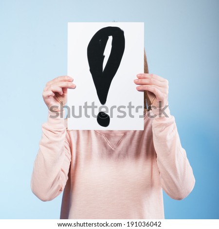 Young woman holding a cardboard with exclamation mark. Photo in color style instagram filters 