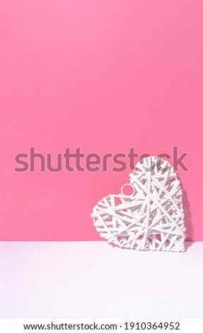 Abstract white heart chilling on pink and white background.