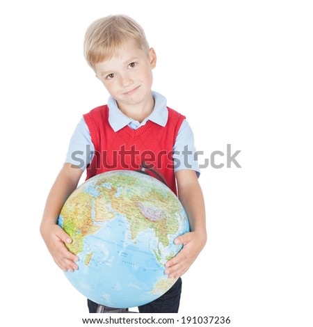 Smiling preschool boy holding a globe on white background