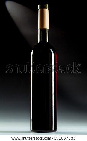 Single wine bottle over dark background