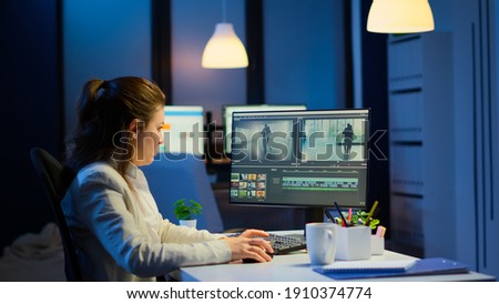 Videographer working at computer from business office, editing video and audio footage at night. Content creator using professional device modern technology network wireless processing film montage.