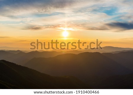 The first or last rays of the sun on a mountain pass. Morning and evening in nature. Colorful sunset and sunrise over the mountain hills. Carpathians in summer and autumn Royalty-Free Stock Photo #1910400466