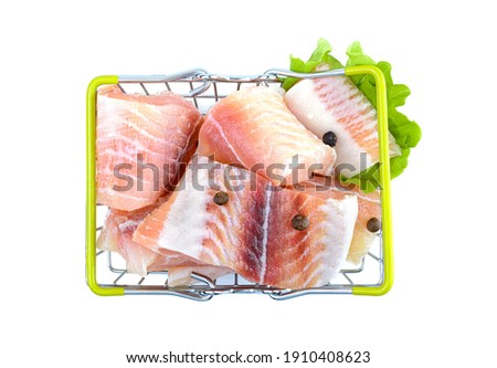 Pangasius fish fillet, sliced into pieces in the shopping basket. Isolated on a white background. Fresh Fish Fillet.