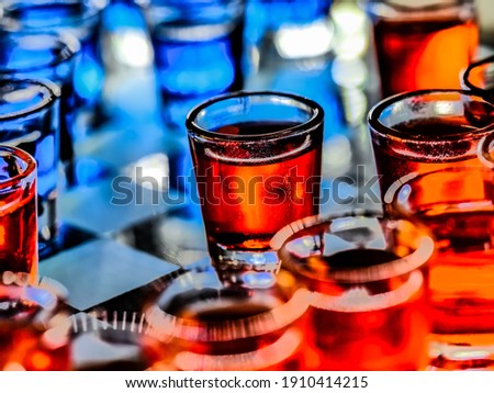 Chess board with shot glasses