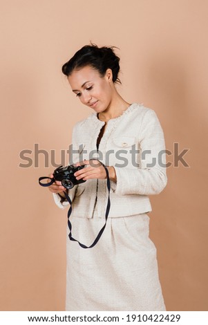 Pleasant african young woman making photos, studio shooting