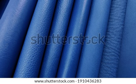 Artificial leather in variety shades of blue colors and variety pattern of texture for classic mood. abstract blue leather sample catalog background.