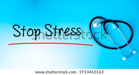 Stop Stress Sign.Text underline with red line. Isolated on blue background with stethoscope. Health concept
