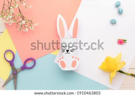 Easter bunny decoration. Paper cut DIY holiday white hand made rabbit.Top view, copy space . funny flatly.