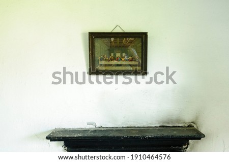 "The Last Supper" picture above an empty fireplace in an Irish cottage