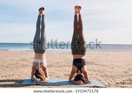 two girls practicing yoga on the beach,yoga poses