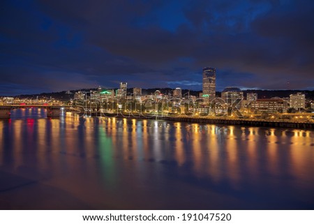 Portland Oregon Downtown City Skyline Along Willamette River Waterfront at Evening Blue Hour with Storm Clouds Panorama