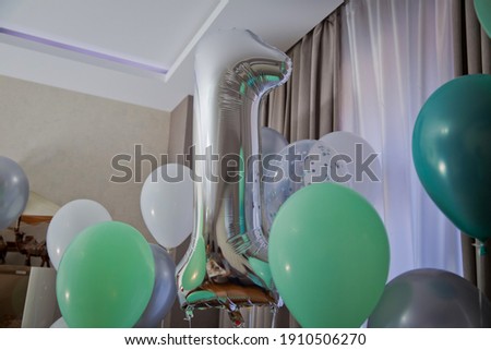One of full number set . Grey number 1 made of inflatable balloon isolated on white background . 1 made of helium balloon . Silver helium balloons 1 number . White and green balloons on your birthday