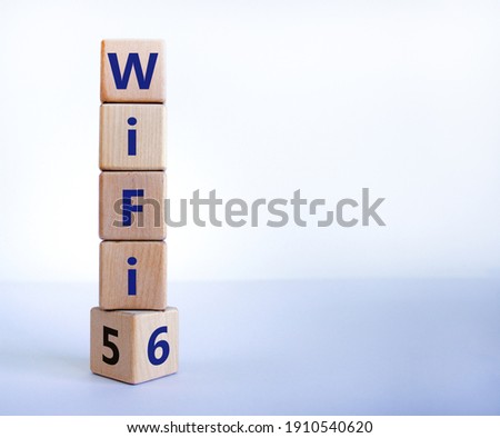 WiFi 5 or 6 symbol. Turned a wooden cube and changed the words WiFi 5 to WiFi 6. Beautiful white background, copy space. Business, technology and WiFi 6 concept.