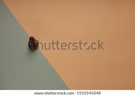 Chess pawn on flat background top view