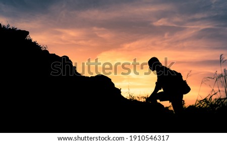 Male hiker starting his climb up a mountain.  Royalty-Free Stock Photo #1910546317