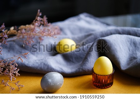 Organic naturally dyed yellow and gray Easter eggs. Stylish holiday decor.