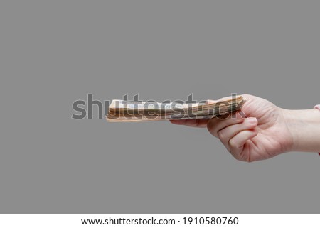 Hand holds a stack of five hundred hryvnia bills, side view. High quality photo