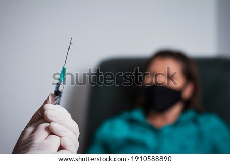 Hands holding syringe containing covid 19 vaccine
