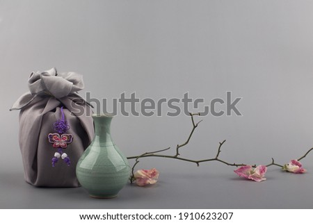Korean traditional wrapping cloth gift box on the gray background Royalty-Free Stock Photo #1910623207