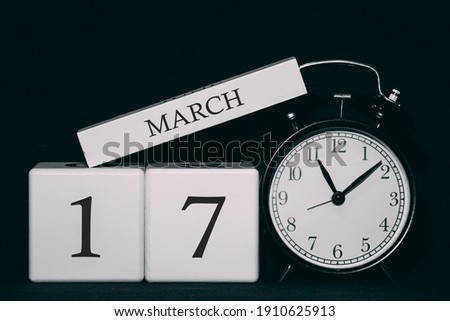 Important date and event on a black and white calendar. Cube date and month, day 17 March. Spring season.