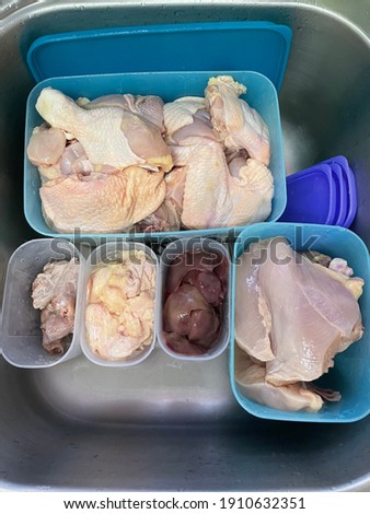 Fresh raw chicken in the containers with noise effect and grain 