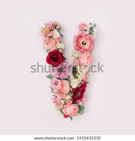 Letter V made of real natural flowers and leaves. Flower font concept. Unique collection of letters and numbers. Spring, summer and valentines creative idea. Royalty-Free Stock Photo #1910635330