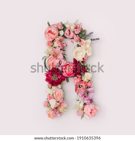 Letter R made of real natural flowers and leaves. Flower font concept. Unique collection of letters and numbers. Spring, summer and valentines creative idea. Royalty-Free Stock Photo #1910635396