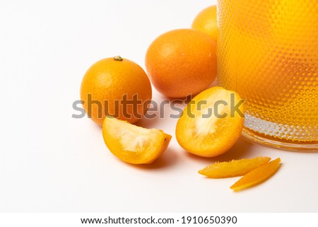 Multiple small kumquats on a pure white background