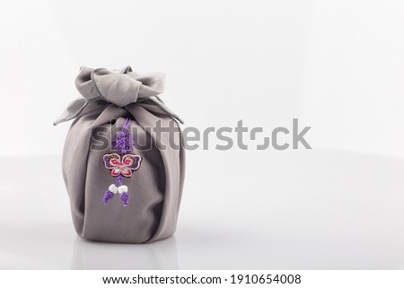 Korean traditional wrapping cloth gift box on the white background Royalty-Free Stock Photo #1910654008