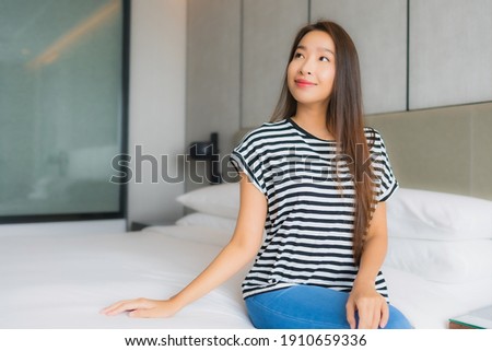 Portrait beautiful young asian woman relax happy smile in bedroom interior