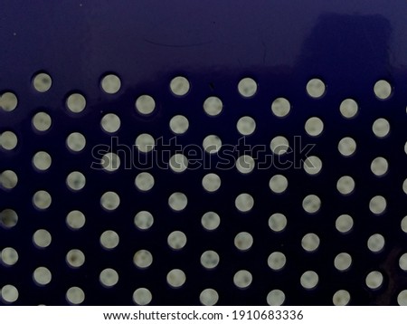 steel of the seat is blue. Drill holes arranged in an orderly manner. Like there are white spots on a blue background