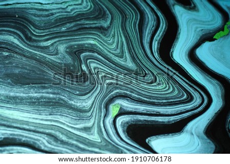 The background image in green or blue tones and has a mix of black, strange patterns and gradations to create a marble pattern
