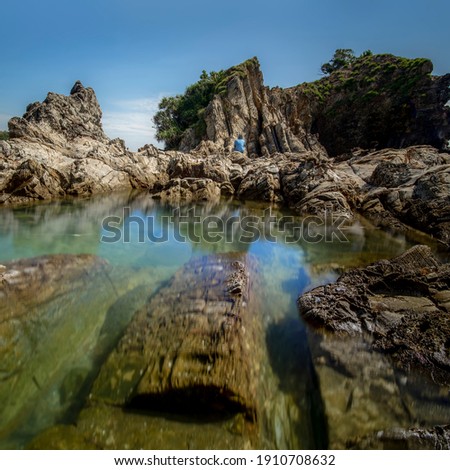 A part of beautiful Kapas Island, Malaysia with unique formation rocks and clear water, long exposure photography., soft and grain effect.