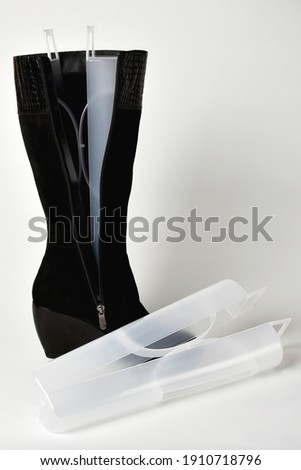 Plastic shoe lasts for high boots on a white background.