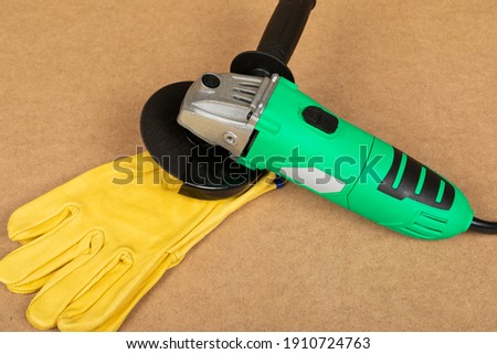 Picture of a green angle grinder on a wooden background
