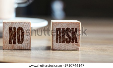 No Risk words on wooden blocks and cacao cup. Risk management concept.