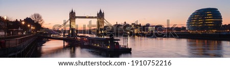 London - Panorama view along the river thames showing Tower Bridge and City Hall  with Tower Millennium Pier in the foreground