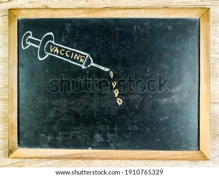 Drawing of vaccine syringe  on blackboard ,  in studio Thailand