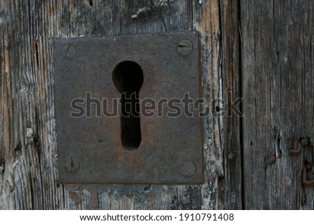 Rusty ancient lock of an old portal of a disused church Royalty-Free Stock Photo #1910791408