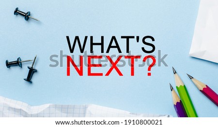 Text what is next on a white notepad with pencils on a blue background. Business concept
