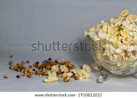 A bowl of popcorn on an old table.