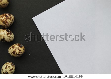 White piece of paper on a black background with eggs. Design of notepad, cards. Bakery products

